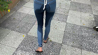 Public Wetting Jeans in Park Near the Beach