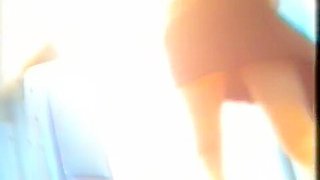 Sexy butted gal lifts and skirt and pisses on toilet