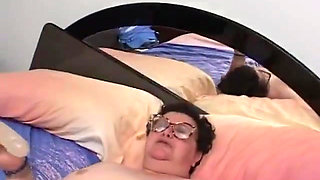 Old fat woman has solo sex in her bed with a dildo