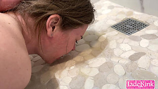 Submissive slut drinking piss from bathroom floor after sex