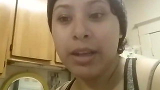 Busty Latina squeezing milk out of her tit at home