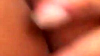 Amateur on the bed at home rubs her hairy pussy