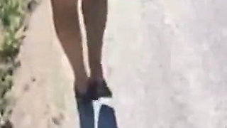Mel walking on the side of the road