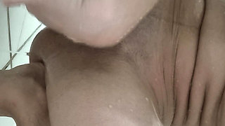 Brunette takes a shower and shaves