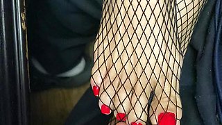 Tiny feet in fishnet stocking...red toe nails