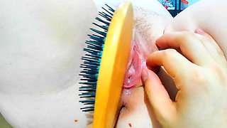 rubbing her clit with the handle until it vibrates