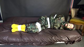 Watching Sexy Pia Being Tied And Gagged With Tape On A Bed Wearing A Sexy Camouflage Shiny Nylon Rainpants And A Rainjacket As Well As Yellow Rubber Boots (Video)