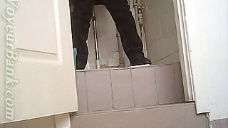 White chick in ugly baggy black pants pissing in the toilet