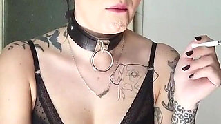 Tattooed gothic lady smoking in the kitchen