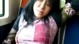Asian milf rubs her clit on a train.