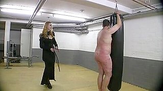 Very hot redhead mistress in leather whipping tied up slave
