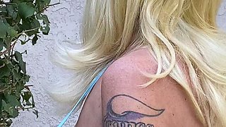 Blonde is flashing her big boobs in the outdoors
