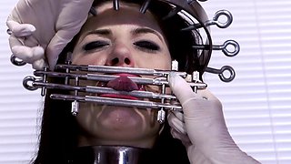 In a kitchen a sexy brunette playing with her big boobs