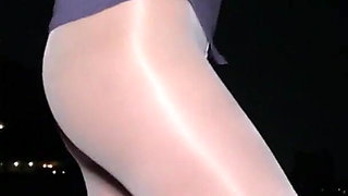 Anna in white shiny pantyhose on the night beach