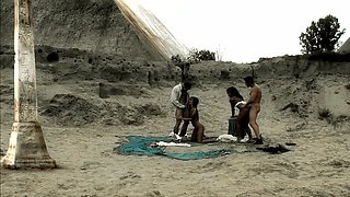 Naked men drill their sluts in a flawless foursome by the beach