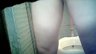 Pale skin chick in the public toilet room wipes her pussy with paper
