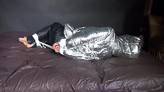 Watching Sexy Sandra Being Tied And Gagged On A Bed With Ropes And A Ballgag Wearing A Supersexy Shiny Black Nylon Pants And A Silver Down Jacket (Video)