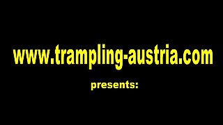 Bathroom balancing on human mat while applying her make up