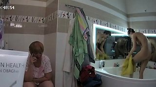 mom and daughter use the bathroom