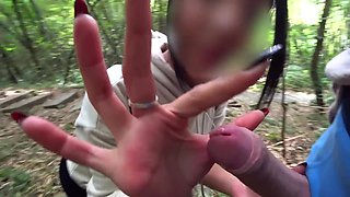 MILF gives big cock handjob during forest walk