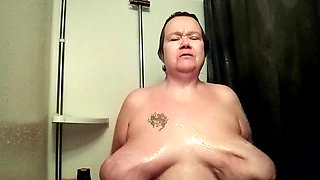 Jen is playing with her own tits in the shower