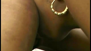 Ebony gets bent over and girl fucks her with strapon cock from behind
