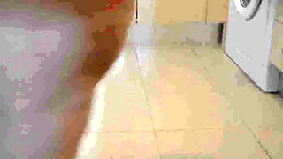 Jen is pissing into a red bowl in the kitchen