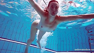 Skinny girl out in the pool cosplaying nirvana album cover underwater