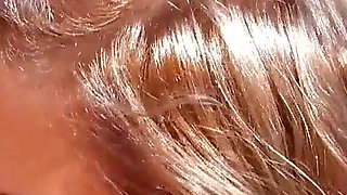 A slut with two soft breasts and blonde hair is ready for some ass fucking on the beach