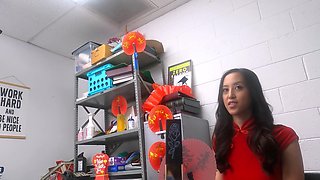 An officer checks the id of a pretty asian couple in the office