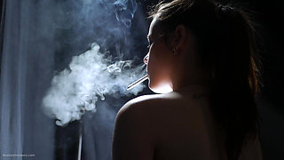Topless Brunette Smoking in Dramatic Smoke