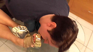 Mistress lets her slave lick her golden shoes