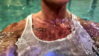 Amazon Kandy Flexes Her Massive Biceps in Her Hotel Pool