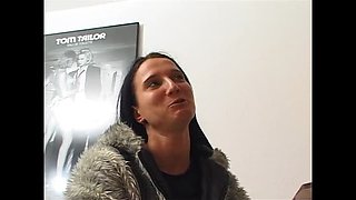 Brunette slut fingers her wet pussy on casting couch