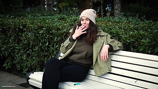 Young Brunette Is Taking an Unhurried Stroll with Allwhite 120mm Cigarette