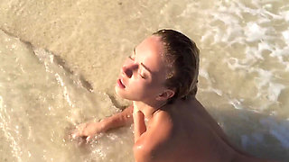 Young beauty Delilah G on the beach