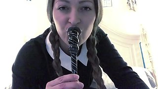 Braided woman in a black dress and pantyhose uses a fucktoy
