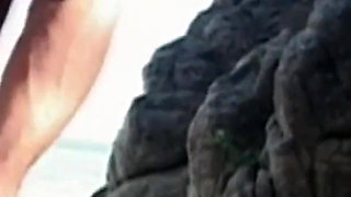 Horny couple fucking on the end of a beach