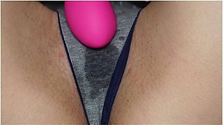 Wet panties betray her arousal as she touches herself