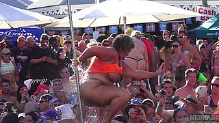 Mature Blondie flaunts her fakes in a skimpy bikini at the beach