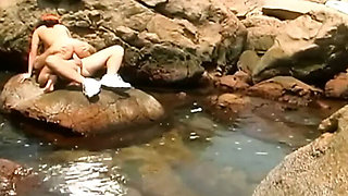 Amateur Brunette in Orange Cap Solo Striptease on Rocks by Natural Pool